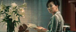 ... on Hon Sam's wife Mary (Carina Lau Ka-ling) in Andrew Lau Wai-keung and Alan Mak’s Infernal Affairs II (2003)