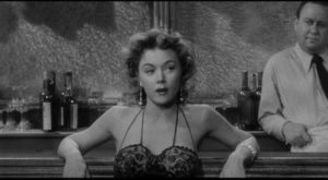Marianna (Gloria Grahame) survives by singing in a border town dive in Jerry Hopper's Naked Alibi (1954)