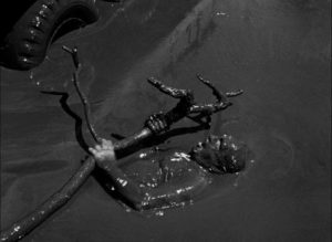 M. Jo (Charles Vanel) is pinned under the truck wheels in a crater full of crude oil in Henri-Georges Clouzot’s The Wages of Fear (1953)