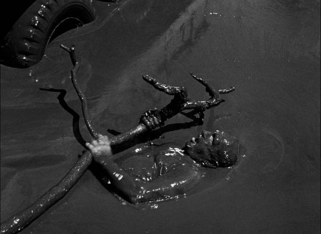 M. Jo (Charles Vanel) is pinned under the truck wheels in a crater full of crude oil in Henri-Georges Clouzot’s The Wages of Fear (1953)
