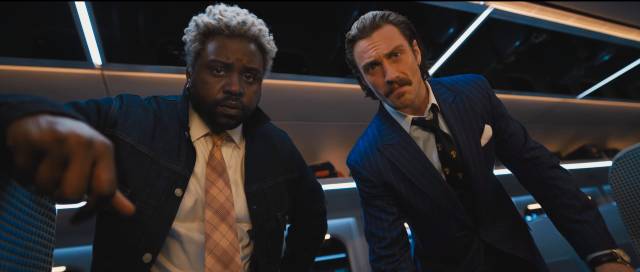 Mismatched brothers Lemon (Brian Tyree Henry) and Tangerine (Aaron Taylor-Johnson) bicker about Thomas the Tank Engine as they kill people in David Leitch's Bullet Train (2022)