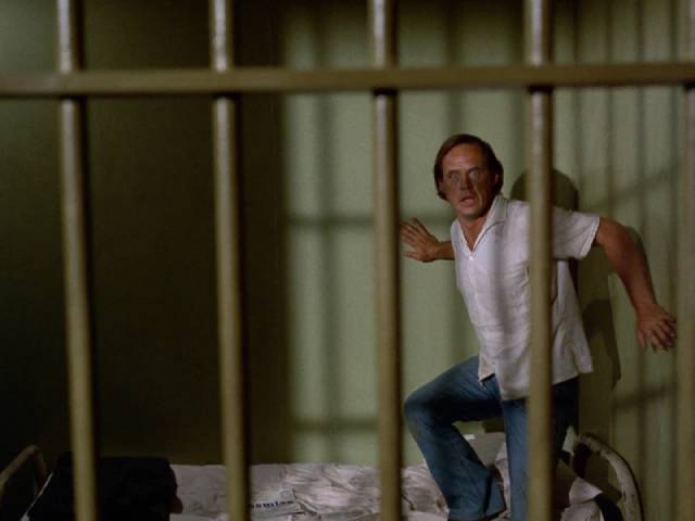 The dead woman’s brother Lawrence (Geoffrey Lewis) isn't safe even in jail in Daniel Petrie's Moon of the Wolf (1972)