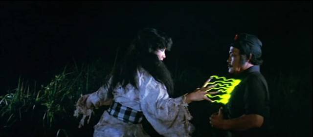 The rejuvenated Leák Queen (Debbie Cinthya Dewi) zaps Mahendra's uncle with her magical power in H. Tjut Djalil’s Mystics in Bali (1981)