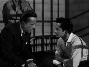 Big-shot attorney Andrew Morton (Humphrey Bogart) knows he's failing slum kid Nick Romano (John Derek) in Micholas Ray's Knock On Any Door (1949)