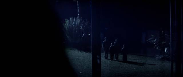 Watchers gather in the grounds in accusatory silence in Jayro Bustamante’s La llorona (2019)