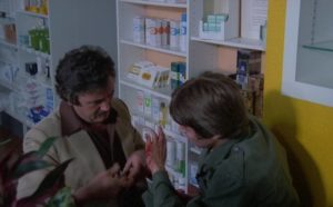 Dr. Henri Ferret (Victor Lanoux) tends to a dog bite in Alain Jessua's Les Chiens (1978)