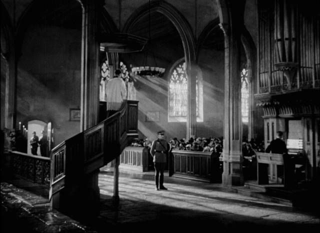 A German officer interrupts a church service where British airmen are hiding in plain sight in Michael Powell's One of Our Aircraft Is Missing (1942)