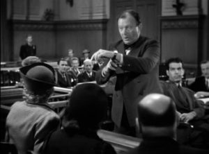 Defense attorney Francis X. O'Leary (Willard Robertson) gives a histrionic summation in Mitchell Leisen's Remember the Night (1940)