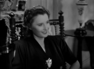 Lee (Barbara Stanwyck) can't quite believe the warm atmosphere in the Sargent family home in Mitchell Leisen's Remember the Night (1940)
