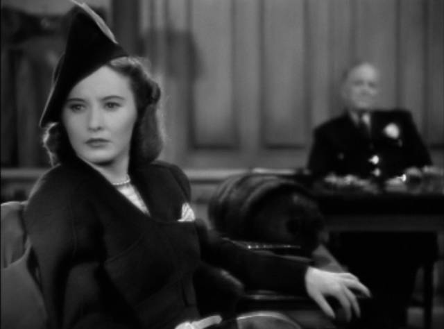 Defendant Lee Leander (Barbara Stanwyck) overhears a demeaning comment from the prosecution in Mitchell Leisen's Remember the Night (1940)
