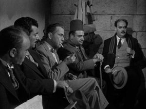 Harry Smith (Humphrey Bogart) is called in by the French authorities in Curtis Bernhardt's Sirocco (1951)