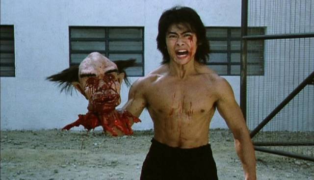 Ricky (Fan Siu-wong) with the warden's severed head at the climax of Lam Ngai-Choi’s Riki-Oh (1991)