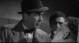 Seeing Toro (Mike Lane) beaten awakens Eddie (Humphrey Bogart)'s conscience in Mark Robson's The Harder They Fall (1956)