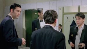 Jack (Clive Owen) is repelled by fellow croupier Matt (Paul Reynolds)'s lack of discipline in Mike Hodges' Croupier (1997)