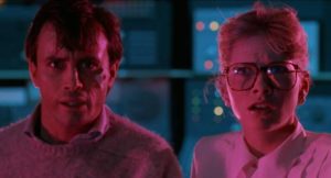 Tillinghast (Jeffrey Combs) and Dr. Katherine McMichaels (Barbara Crampton) don't like what they see coming through the gate in Stuart Gordon's From Beyond (1986)