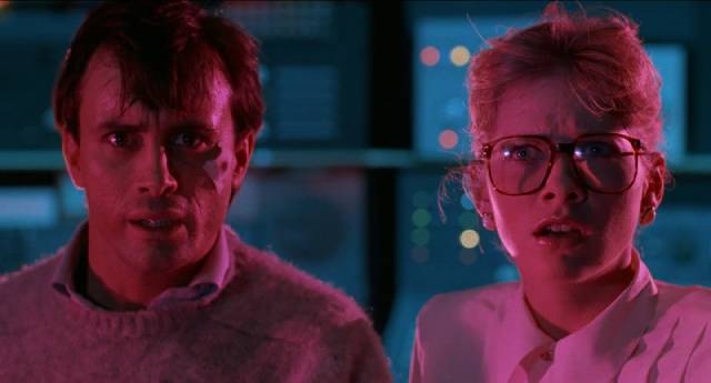 Tillinghast (Jeffrey Combs) and Dr. Katherine McMichaels (Barbara Crampton) don't like what they see coming through the gate in Stuart Gordon's From Beyond (1986)