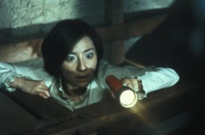 Rika (Megumi Okina) finds something unpleasant in the attic in Takashi Shimizu's Ju-On: The Grudge (2002)
