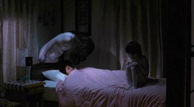 Toshio (Yuya Ozeki) and his mother Kayako (Takako Fuji) gang up on victims in Takshi Shimizu's Ju-On