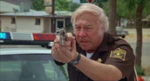 Veteran sheriff Hanks (George Kennedy) sees his small-town neighbours going mad in Nico Mastorakis' Nightmare at Noon (1988)