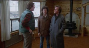 Charles (John Heward) and Sam (Peter Riegert) pay a mocking visit to Laura's husband Ox (Mark Metcalf) in Chilly Scenes of Winter (1979)