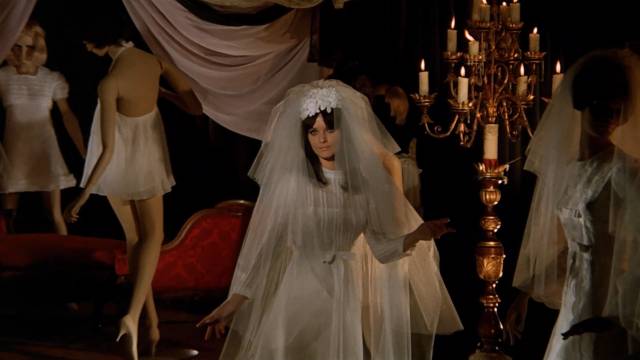 Model Alice Norton (Femi Benussi) makes the mistake of accepting the gift of a bridal gown from John Harrington (Stephen Forsyth) in Mario Bava's Hatchet for the Honeymoon (1970)
