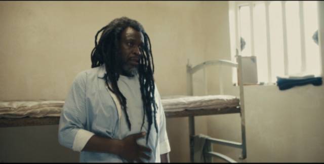 Rastafarian Simeon (Robbie Gee) undertakes to educate his new cell-mate in Steve McQueen's Alex Wheatle (2020)
