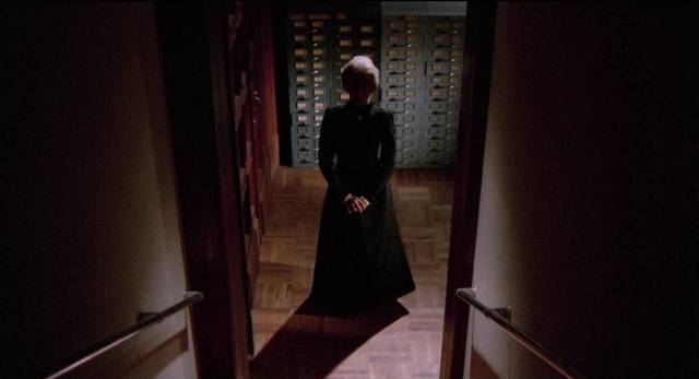 The angry spirit of Aunt Susana (Tamara Garina) stalks Aurora (Susana Dosamantes) at work in Carlos Enrique Taboada’s Darker Than the Night (1975)