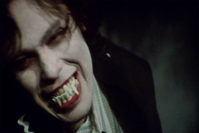 Martin (John Amplas) dons a cloak and fake fangs to mock Cuds (Lincoln Maazel)'s superstitious beliefs and also his own self-mythologizing in George A. Romero's Martin (1976)