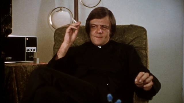 Father Howard (George A. Romero) doesn't show much interest in the spiritual side of religion in George A. Romero's Martin (1976)
