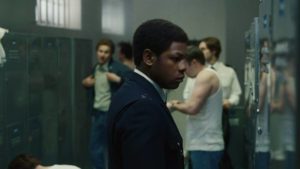 A fellow constable scrawls racist slurs on Leroy Logan (John Boyega)'s locker in Steve McQueen's Red, White and Blue (2020)