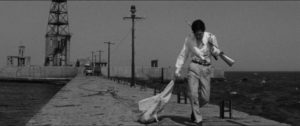 Hanada (Joe Shishido) walks away from a deadly ambush in Seijun Suzuki's Branded to Kill (1967)