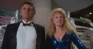 Developer Harv Posner (Jonathan Goldsmith) and Mayor Karen Wilton (Morgan Fairchild) embrace Capitalism in Richard Friedman's Phantom of the Mall: Eric’s Revenge (1989)