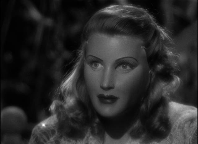 Concealed by a mask, Henrietta (Betty Field) can finally be her true self in Julien Duvivier's Flesh and Fantasy (1943)