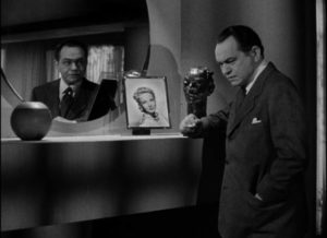 Attorney Marshall Tyler (Edward G. Robinson) is taunted from the mirror by his own conscience in Julien Duvivier's Flesh and Fantasy (1943)