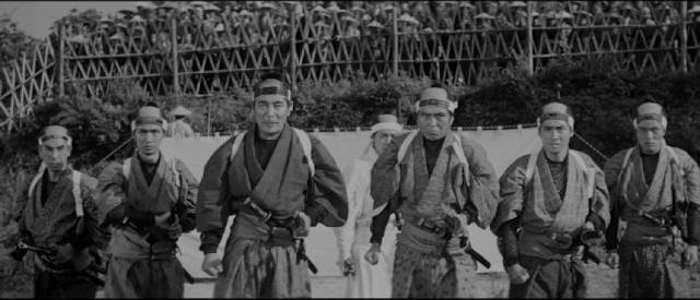 The duel is rigged and Shinpachi Ezaki (Kinnosuke Nakamura) finds himself facing six retainers instead of his challenger in Tadashi Imai's Revenge (1964)