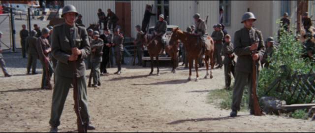 Soldiers block the road as striking workers march towards them in Bo Widerberg's Ådalen 31 (1969)