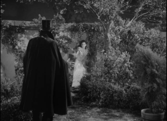 The Catman corners Marie Audet (Lenore Aubert) in a Parisian park in Lesley Selander's The Catman of Paris (1946)