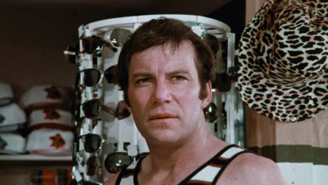 Matt Stone (William Shatner) realizes that Tina Moy (Kim Nicholas) is on to his secret in William Grefé’s Impulse (1974)