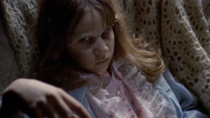 Regan (Linda Blair) and her demon are irritated by officious adults in William Friedkin's The Exorcist (1971)