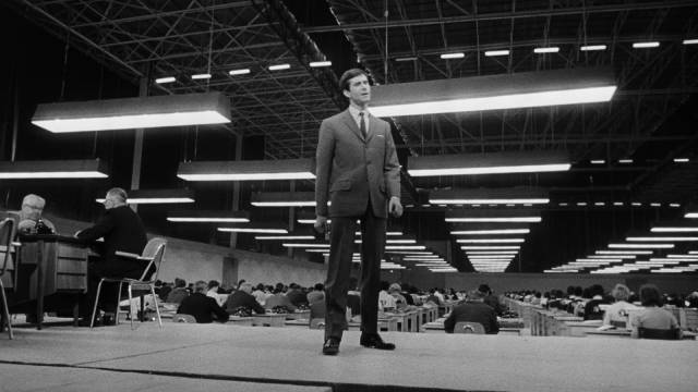 Josef K. (Anthony Perkins) oversees a vast room full of clerks in Orson Welles's The Trial (1962)