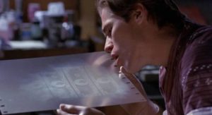 Artist/counterfeiter Eric Masters (Willem Dafoe) creates printing plates in William Friedkin's To Live and Die in L.A. (1985)
