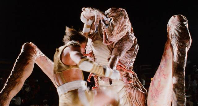 Steve Armstrong (Paul Satterfield) fights a giant alien bug in Peter Manoogian's Arena (1989)