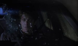 James Ballard (James Spader) sits in shock after causing a collision in David Cronenberg's Crash (1996)