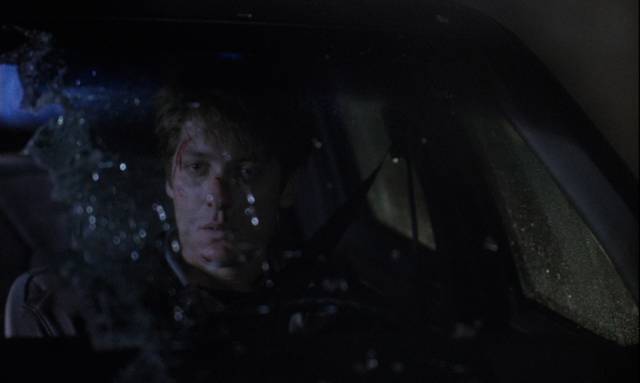 James Ballard (James Spader) sits in shock after causing a collision in David Cronenberg's Crash (1996)