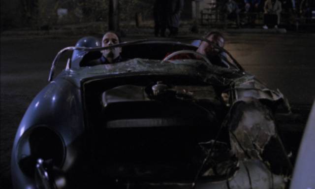 Vaughan (Elias Koteas) and stunt driver Colin Seagrave (Peter MacNeill) survive the restaging of James Dean's fatal collision in David Cronenberg's Crash (1996)