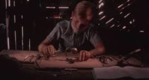 Nicholas (Jeff Sutton) dissects bugs in Jeff Erbach's The Nature of Nicholas (2002)