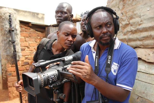 Isaac Nabwana, aka Nabwana I.G.G. and his crew shooting a movie in Cathryne Czubek’s Once Upon a Time in Uganda (2021)