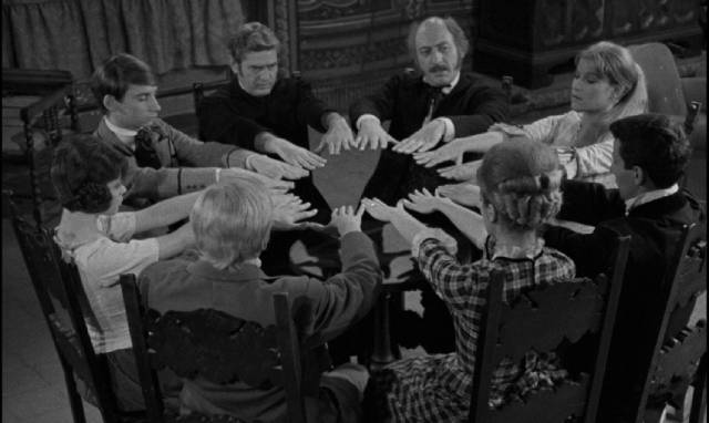 Assembled for the reading of a will the guests hold a seance in Garibaldi Serra Caracciolo’s The Seventh Grave (1966)