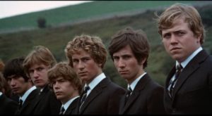 The boys of Lower 5B watch silently as their teacher is laid to rest in a country churchyard in John Mackenzie's Unman, Wittering and Zigo (1971)