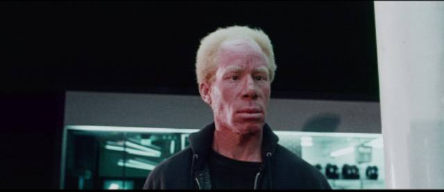 An albino trucker (Bennie Robinson) is one of the unsettling inhabitants of a small coastal town in Willard Huyck and Gloria Katz's Messiah of Evil (1974)